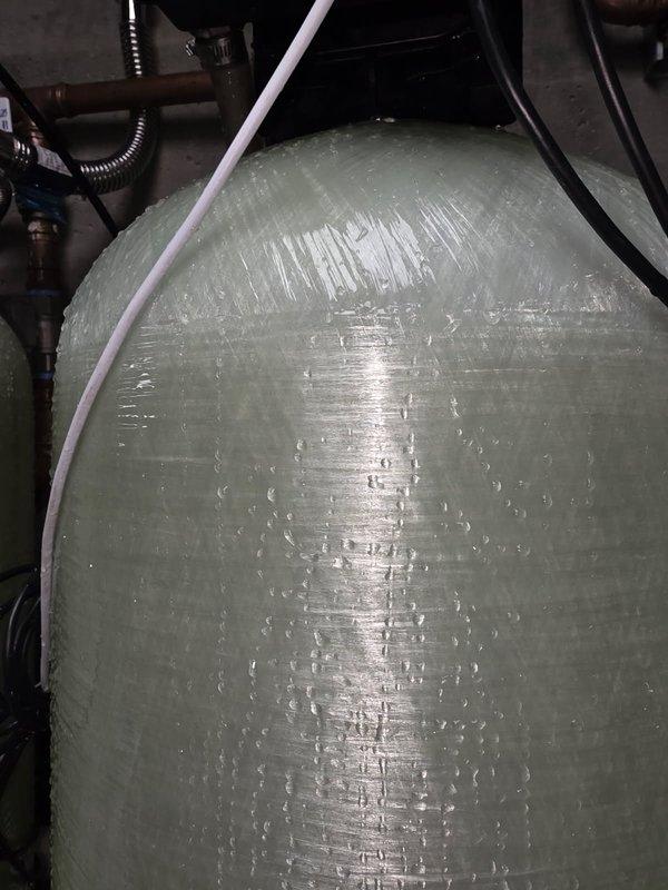 Completed bi-annual preventative maintenance service on commercial HVAC system consisting of 6 package units, 5 split geothermal units, 2 apartment geothermal split systems, and pool heater. Performed comprehensive cleaning and tune-up procedures on all equipment, inspected 6 model #800 steam humidifiers and 5 model #700 humidifiers, and documented filter requirements including various sizes of HVAC filters and humidifier pads. Verified pool heater belt specifications and assessed water treatment system components showing normal condensation patterns on storage tanks.