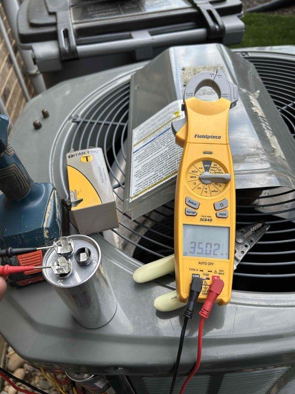 Completed spring maintenance tune-up on 7-year-old residential HVAC system. Inspected attic condensate drain lines and verified proper configuration, checked outdoor condenser unit operation, and performed electrical diagnostics including capacitor testing with readings of 35.02 µF. All components operating within normal parameters.