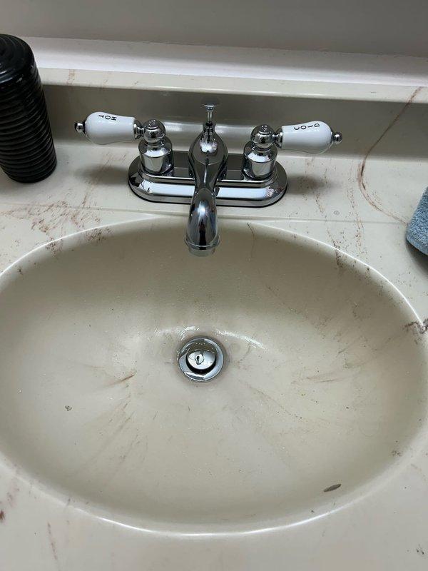 Completed installation of customer-supplied fixtures including a chrome shower head with adjustable curved arm mounted to existing shower plumbing, a two-handle chrome faucet with porcelain caps installed at bathroom vanity sink, and washing machine hookup. Performed leak inspection of all toilets on property to verify proper seal and flush valve operation, with no leaks detected.