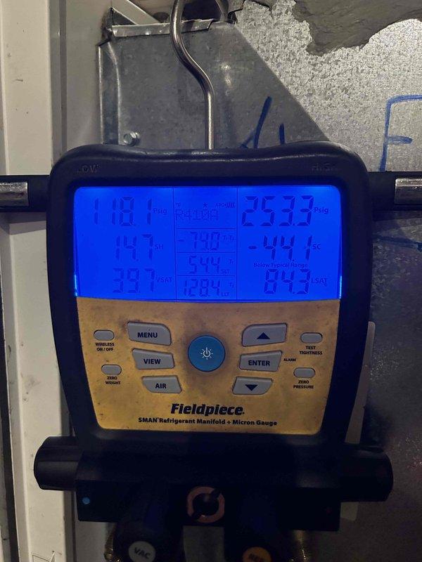Responded to callback for non-operational HVAC system following previous service visit on 3/18. Performed diagnostic testing using refrigerant manifold and micron gauge to assess system pressures and temperatures across multiple units. Measurements indicated pressure readings of 253.3 psig and 84.3 psig with corresponding temperatures, confirming system operational status and proper refrigerant charge levels after troubleshooting.
