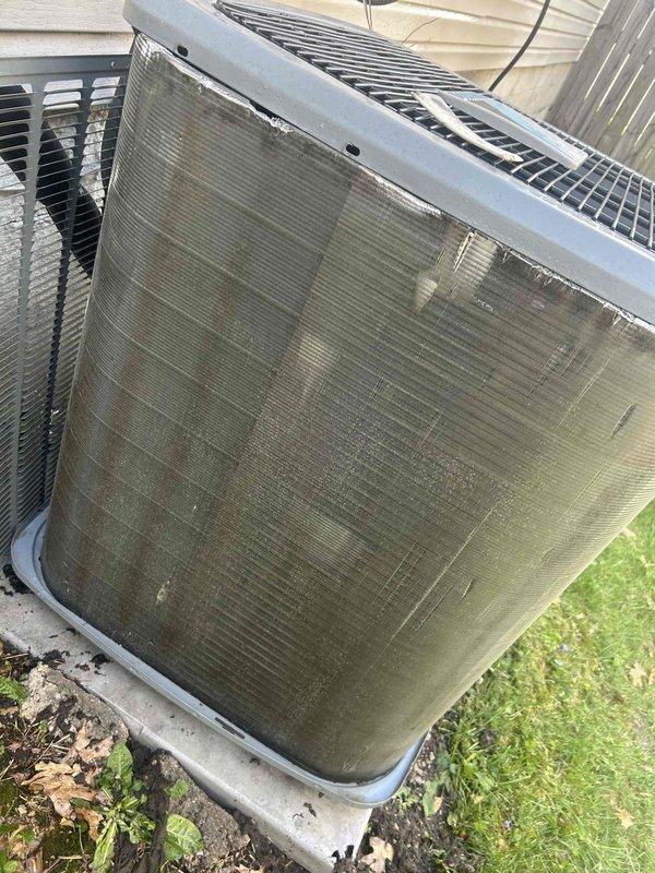 Responded to no-cooling complaint on six-year-old residential air conditioning system. Upon arrival, found outdoor condenser unit with heavily soiled coil fins showing significant accumulation of dirt, dust, and debris, particularly in lower sections, restricting airflow and reducing heat transfer efficiency. Performed thorough coil cleaning to restore proper airflow through condenser. Inspected refrigerant lines, electrical connections, and condensate drainage system. System restored to normal cooling operation following maintenance procedures.