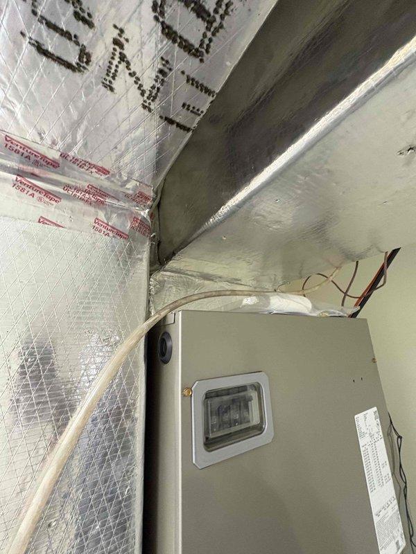 Completed full residential HVAC system installation including Bryant 3.5 ton heat pump model GH5SAN54200A, Bryant 3.5 ton air handler model FJ5ANXC42L00, and Bryant 15KW heat kit model TU-EC-15BKB. Removed and properly disposed of existing equipment. Installed outdoor heat pump unit on new equipment pad with snow legs for elevation and protection. Mounted air handler in attic space with proper clearances and secured to structural supports. Integrated existing thermostat with new system. Installed electrical disconnect box and whip kit for outdoor unit per code requirements. Ran and insulated refrigerant lines between outdoor and indoor units, installed refrigerant line filter. Created transition connections to existing ductwork system. Installed standard air filter rack and SS2 coil drain safety water sensor for condensate overflow protection. Added P-trap to condensate drain line for proper drainage. Completed all electrical connections, tested system startup, verified proper refriger