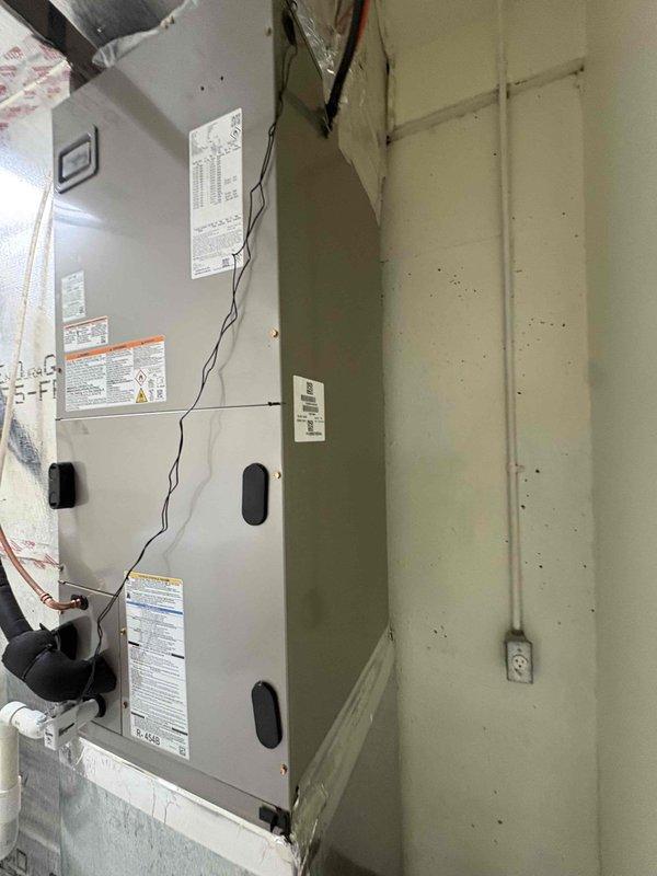 Completed full residential HVAC system installation including Bryant 3.5 ton heat pump model GH5SAN54200A, Bryant 3.5 ton air handler model FJ5ANXC42L00, and Bryant 15KW heat kit model TU-EC-15BKB. Removed and properly disposed of existing equipment. Installed outdoor heat pump unit on new equipment pad with snow legs for elevation and protection. Mounted air handler in attic space with proper clearances and secured to structural supports. Integrated existing thermostat with new system. Installed electrical disconnect box and whip kit for outdoor unit per code requirements. Ran and insulated refrigerant lines between outdoor and indoor units, installed refrigerant line filter. Created transition connections to existing ductwork system. Installed standard air filter rack and SS2 coil drain safety water sensor for condensate overflow protection. Added P-trap to condensate drain line for proper drainage. Completed all electrical connections, tested system startup, verified proper refriger