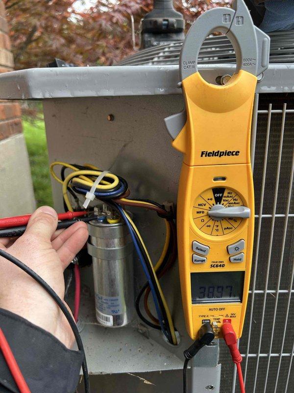 Performed comprehensive HVAC tune-up and system evaluation on residential air conditioning unit. Conducted electrical diagnostics using clamp meter, measuring amperage draw at 30.9 amps and testing capacitor performance to ensure proper compressor and fan motor operation. Inspected evaporator coil fins for cleanliness and airflow efficiency, and verified all electrical connections and components were secure and functioning within manufacturer specifications.