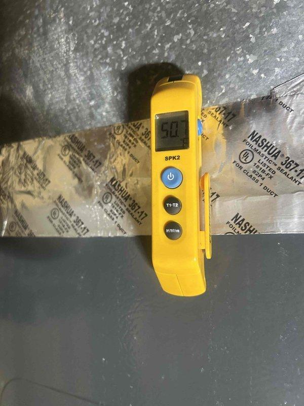 Responded to no-cool call on 6-year-old air conditioning system where outdoor unit failed to operate while indoor blower continued running. Performed diagnostic testing using digital multimeter to measure electrical values at outdoor unit and indoor air handler. Measurements revealed low microamp readings indicating potential control circuit failure or capacitor issue affecting compressor operation. Documented system conditions and electrical readings for further troubleshooting and repair recommendations.