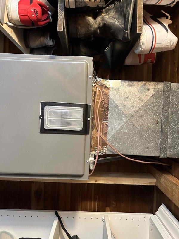 Completed full residential HVAC system installation including Ruud RP14AY30AJ2NA heat pump outdoor unit, RH2TY3617STANNJ air handler, and RXBH-1724A10J-B electric heat kit. Installed outdoor unit on new concrete pad with snow legs, electrical disconnect box, and electrical whip kit. Applied refrigerant line insulation and installed refrigerant line filter. Ran new high voltage wiring to air handler for electric heat strips. Installed air handler in utility closet with trap, SS2 coil drain safety water sensor, ceiling saver overflow drain pan with water sensor, and standard air filter rack. Fabricated transitions to connect to existing ductwork. Replaced condenser fan motor and installed new Honeywell S200 thermostat. Removed and disposed of existing equipment. Obtained applicable permits and ensured code compliance. System tested and verified operational with proper airflow, refrigerant charge, and electrical connections. Provided customer with warranty documentation covering one year 