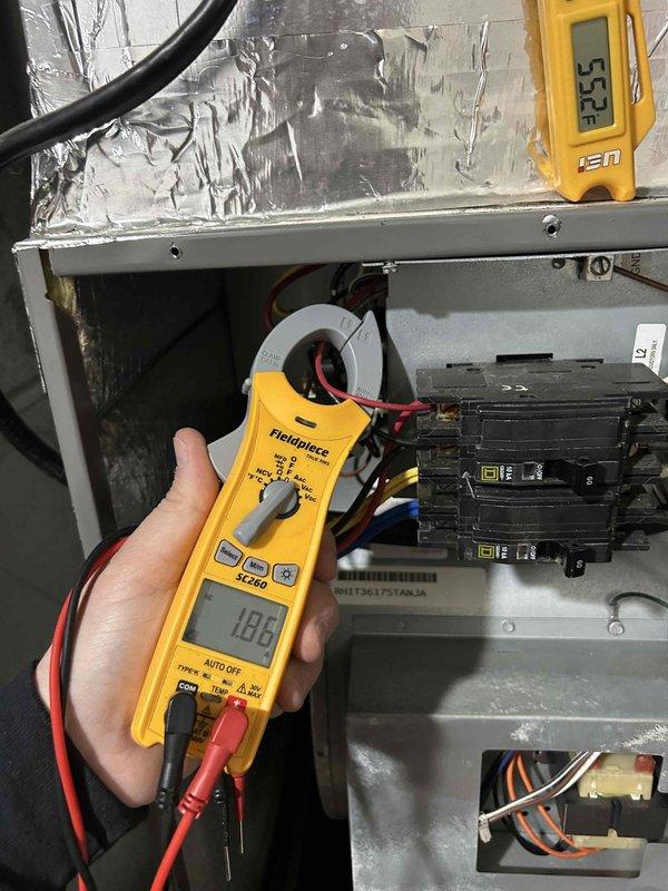 Responded to error code call and performed Gold Level prepaid maintenance tune-up on two heat pump systems in residential property. Upon arrival, system had been reset by customer and was operational. Completed comprehensive diagnostic testing on both units - one located in basement, one on second finished floor. Inspection revealed significant frost accumulation on evaporator coil, indicating potential refrigerant flow or airflow restriction issues. Measured electrical amperage at 18.8A and monitored system temperatures reading 53.3°F. Tested all electrical components including circuit breakers, capacitors, and wiring connections. Performed standard maintenance protocol including system performance verification, electrical testing with clamp meter, and visual inspection of all accessible components. Both systems operating at time of service completion. Customer provides own filters for units.