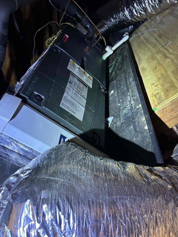 Responded to no cooling complaint on 8-year-old electric HVAC system with air handler located in attic. Upon arrival, performed diagnostic inspection of indoor unit and electrical panel to identify cause of system failure that began Friday. Documented existing equipment configuration including air handler, ductwork, and electrical connections through photo documentation. Noted missing air filter that was not available during previous November maintenance visit.