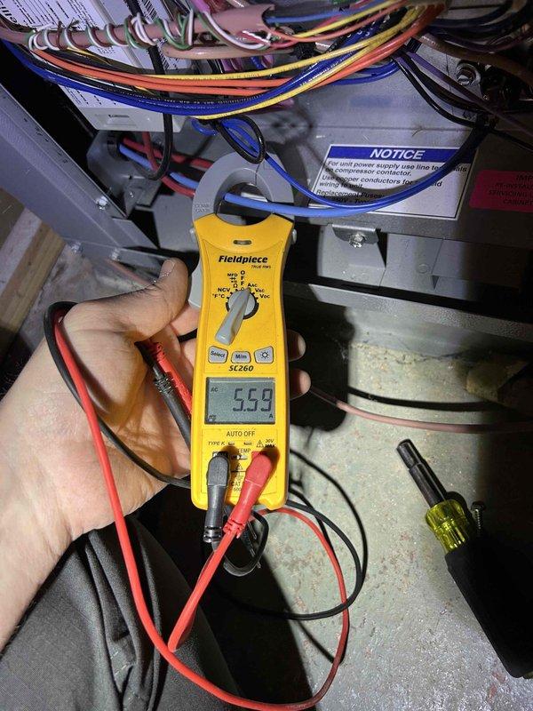 Completed semi-annual maintenance on geothermal split system with ground-source heat pump, air handler located in attic/basement configuration. Performed comprehensive tune-up including electrical diagnostics with clamp meter readings, verified amperage draw at 5.59 amps on measured circuit, and inspected all accessible components. Evaluated outdoor condenser unit condition, checked proper elevation on support blocks, and confirmed adequate clearance around unit for airflow; customer provides their own filters for this system.