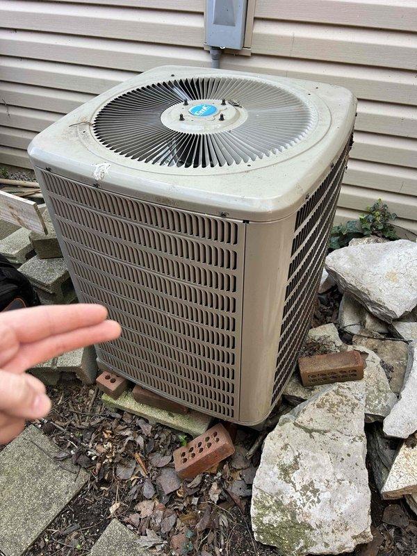 Completed semi-annual maintenance on geothermal split system with ground-source heat pump, air handler located in attic/basement configuration. Performed comprehensive tune-up including electrical diagnostics with clamp meter readings, verified amperage draw at 5.59 amps on measured circuit, and inspected all accessible components. Evaluated outdoor condenser unit condition, checked proper elevation on support blocks, and confirmed adequate clearance around unit for airflow; customer provides their own filters for this system.