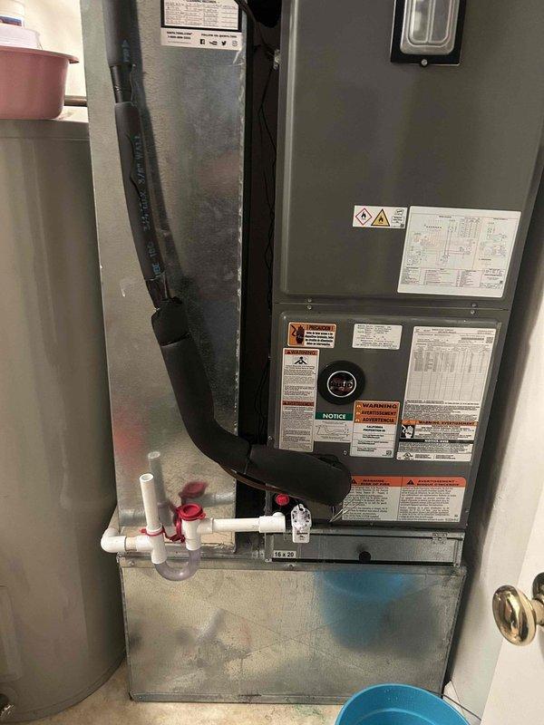 Responded to water leak complaint on recently installed Ruud 14.3 SEER 2-stage heat pump system. Upon inspection, identified leaking condensate drain trap assembly with compromised seal at PVC connection point. Disassembled drain trap, cleaned components, resealed connections with appropriate primer and cement, and reassembled drainage system. Verified proper trap configuration and tested system operation to confirm leak resolution with no further water accumulation observed.