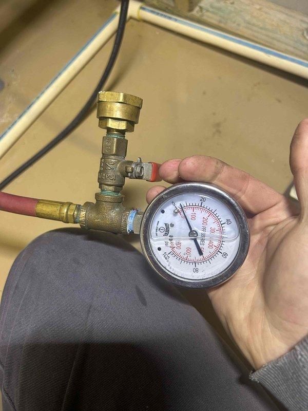Completed comprehensive maintenance tune-up on geothermal HVAC system with humidifier located in basement. Performed thorough electrical diagnostics using clamp meter, verifying amperage draw at 102.5 amps and inspecting all control board connections and wiring harnesses to ensure proper operation. Measured system pressures using calibration gauges at brass valve manifold to confirm refrigerant charge and loop performance within manufacturer specifications. Verified all electrical connections were secure and properly seated, with special attention to ensuring no components were left disconnected. Customer provided replacement air filters and humidifier pad as requested for seasonal maintenance protocol.