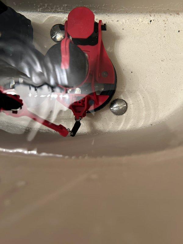 Responded to callback for recently installed toilet that was running continuously with intermittent bowl water loss. Upon inspection, identified faulty Fluidmaster fill valve assembly causing constant refill cycles. Removed defective red fill valve unit and replaced with new assembly, ensuring proper mounting and secure connections to water supply line. Adjusted float mechanism and verified proper shutoff operation. Tested system through multiple flush cycles to confirm bowl maintains proper water level and fill valve shuts off completely without continuous running.