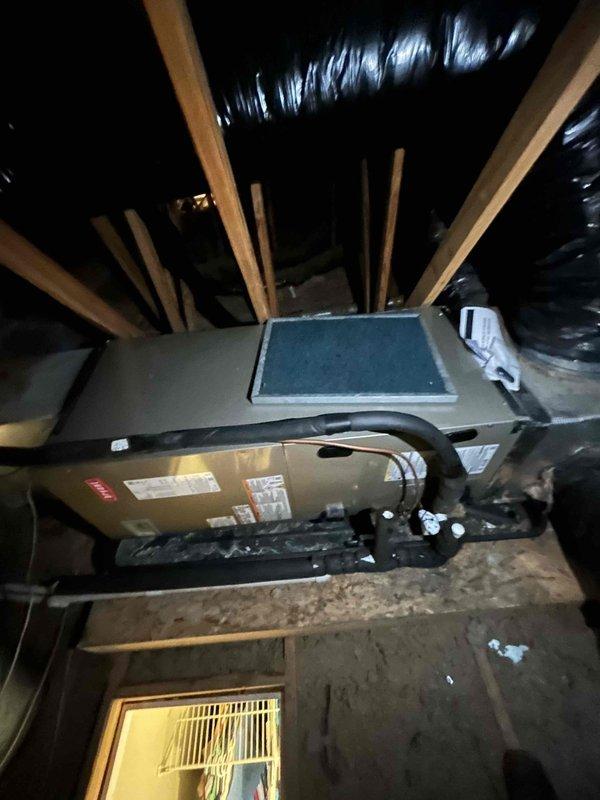 Completed full residential heat pump system installation including Bryant 2.5 ton 14.3 SEER2 heat pump outdoor unit (model GH5SAN53000A), Bryant 2.5 ton air handler (model FJ5ANXB30L10), and Bryant 10KW electric heat kit (model TU-EC-10BKB). Installed Honeywell digital thermostat for system control. Mounted outdoor unit on concrete pad with snow legs for elevation and proper drainage. Installed electrical disconnect box and whip kit at outdoor unit location. Ran insulated refrigerant lines from outdoor unit to attic-mounted air handler, secured along exterior brick wall with proper mounting hardware. Installed refrigerant line filter drier for system protection. Positioned air handler horizontally between attic joists with proper support and clearances. Connected black flexible insulated ductwork to air handler and integrated with existing duct system using custom transitions. Installed standard-sized air filter rack for maintenance access. Added SS2 coil drain safety water sensor and 