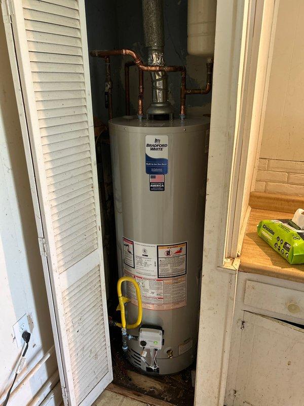 Installed a new Bradford White 40-gallon gas water heater with proper copper piping connections, expansion tank, and venting system. The installation included connecting hot and cold water lines with shutoff valves, securing the flue pipe for proper exhaust ventilation, and ensuring all connections meet code requirements. Unit was tested and verified operational upon completion.