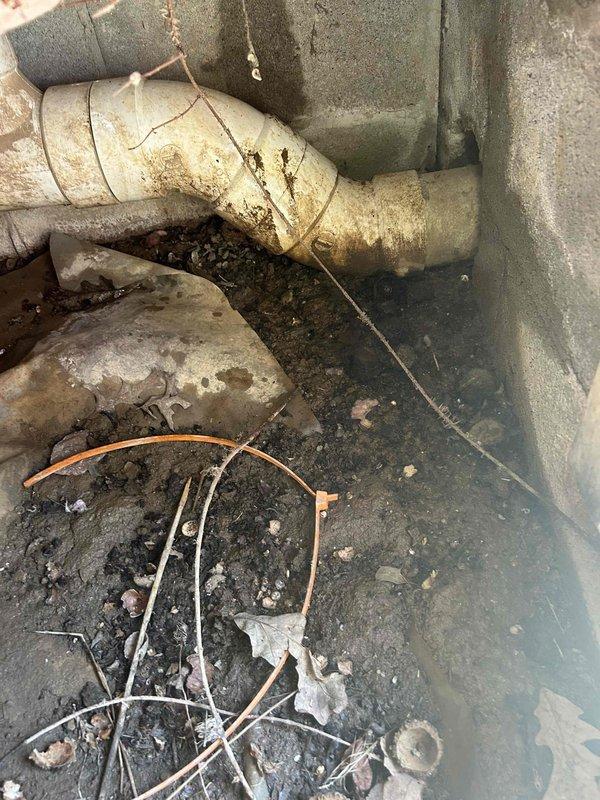 Completed comprehensive AC tune-up on 9-year-old cooling system. System operating properly upon arrival with customer reporting malodor from supply vents during operation. Performed standard maintenance protocol including filter inspection, refrigerant level verification, electrical connection testing, condensate drain evaluation, and airflow assessment. 

Inspected accessible ductwork and plumbing infrastructure in utility areas. Documented deteriorated pipe insulation, corroded PVC drainage components with visible rust staining at penetration points, and compromised condensate line conditions contributing to odor complaints. Identified moisture intrusion evidence on structural elements and accumulated debris in drain pan area affecting air quality.

Recommended immediate attention to condensate drainage system repairs, duct cleaning services, and replacement of degraded pipe insulation to eliminate odor source and prevent further system contamination. System left in operational condi