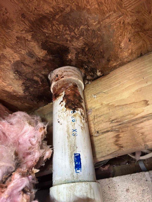 Completed comprehensive AC tune-up on 9-year-old cooling system. System operating properly upon arrival with customer reporting malodor from supply vents during operation. Performed standard maintenance protocol including filter inspection, refrigerant level verification, electrical connection testing, condensate drain evaluation, and airflow assessment. 

Inspected accessible ductwork and plumbing infrastructure in utility areas. Documented deteriorated pipe insulation, corroded PVC drainage components with visible rust staining at penetration points, and compromised condensate line conditions contributing to odor complaints. Identified moisture intrusion evidence on structural elements and accumulated debris in drain pan area affecting air quality.

Recommended immediate attention to condensate drainage system repairs, duct cleaning services, and replacement of degraded pipe insulation to eliminate odor source and prevent further system contamination. System left in operational condi
