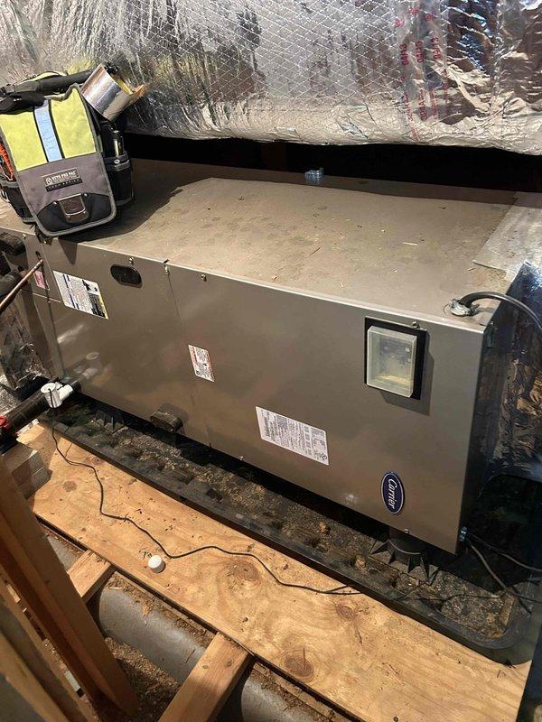 Responded to no cooling complaint on dual-zone residential system with 11-year-old attic unit and 5-year-old basement unit. Diagnosed blower motor fault (error code 41) on attic Carrier Infinity system as indicated by thermostat display showing "System Fault - Blower Motor Fault" with indoor temperature at 68°F and outdoor temperature at 64°F. Inspected air handler unit in attic installation and confirmed blower motor failure preventing airflow and cooling operation. Advised customer of blower motor replacement requirement to restore cooling function to attic zone. Additionally noted basement system requires humidifier pad replacement for proper humidity control.