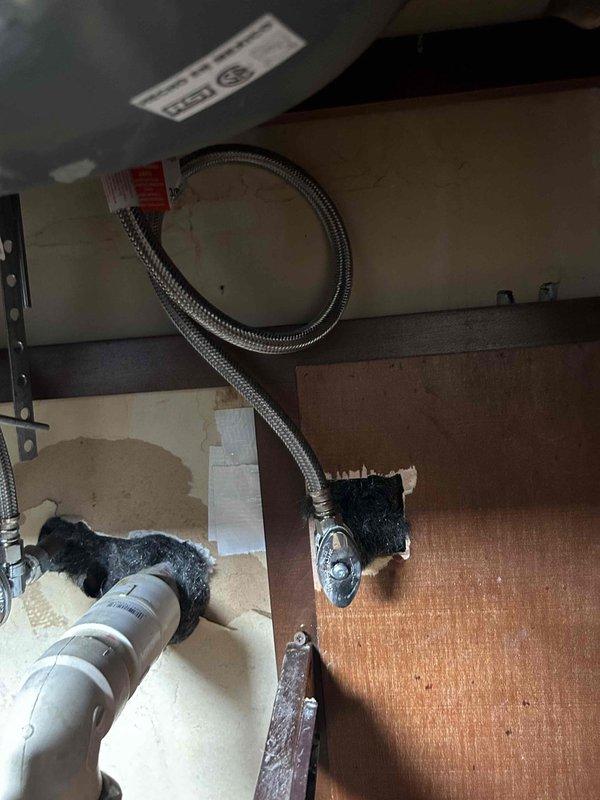 Completed bathtub drain repair by replacing the waste and overflow assembly and installing a new P-trap to eliminate leaking during use. Removed and disposed of the old water heater, then installed a new Bradford White unit using copper fittings. Removed existing flexible hoses and recirculating pump, tied in the new heater with proper copper connections, and reconfigured lavatory plumbing connections to accommodate the system without the recirculating pump. Verified all connections for proper operation and tested for leaks before completing the installation.