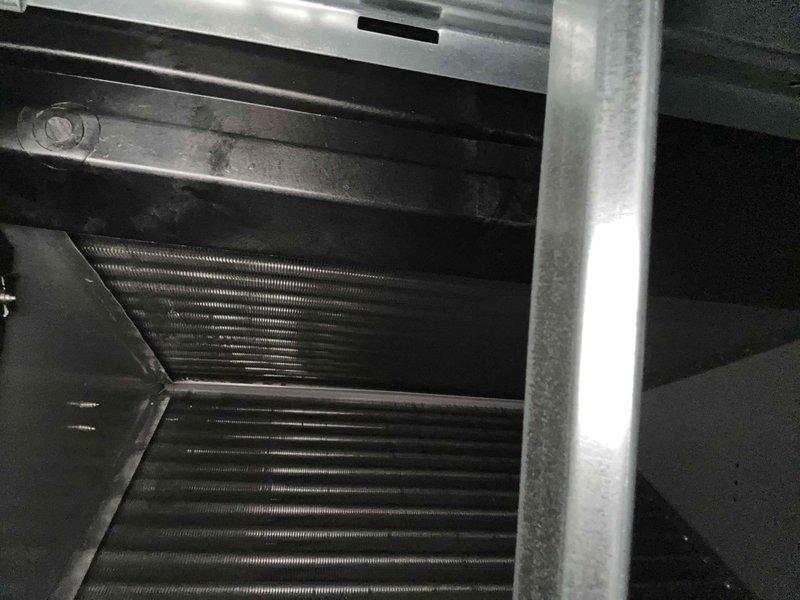 Completed preventive maintenance tune-up on single-zone HVAC system consisting of one heat pump and one air handler with washable filter. Inspected evaporator coil and noted accumulated dust and debris on aluminum fins, documented condition through photography. Applied algaecide strips to condensate drain pan as requested to prevent biological growth and maintain proper drainage.