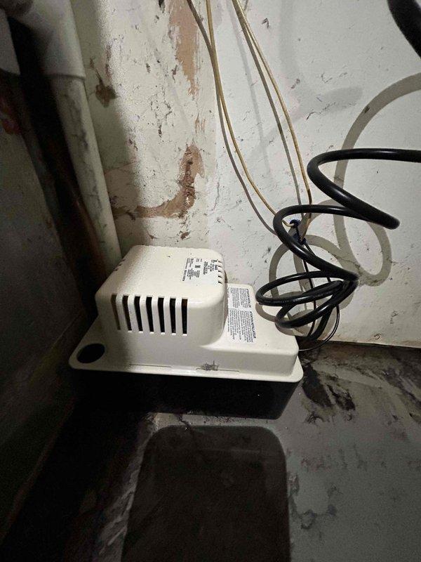 Completed full residential HVAC system installation including Carrier 16 SEER2 Comfort Series 4-ton heat pump (model 27SCA548A003), 4-ton air handler (model FJ5ANXC48L00), and 15KW heat kit (model AFAEHL15B01A). Installed digital thermostat, condensate pump with SS2 coil drain safety water sensor, ceiling saver overflow drain pan with water sensor, and standard air filter rack. Outdoor installation included new equipment pad with gravel base fill, snow legs, electrical whip kit, disconnect box, insulated refrigerant lines with filter, and all necessary brass fittings and service valves. Indoor air handler installation included trap, transition to existing ductwork, and proper drainage system. Pulled applicable permits, removed and disposed of existing equipment, and completed all electrical connections per code compliance standards.