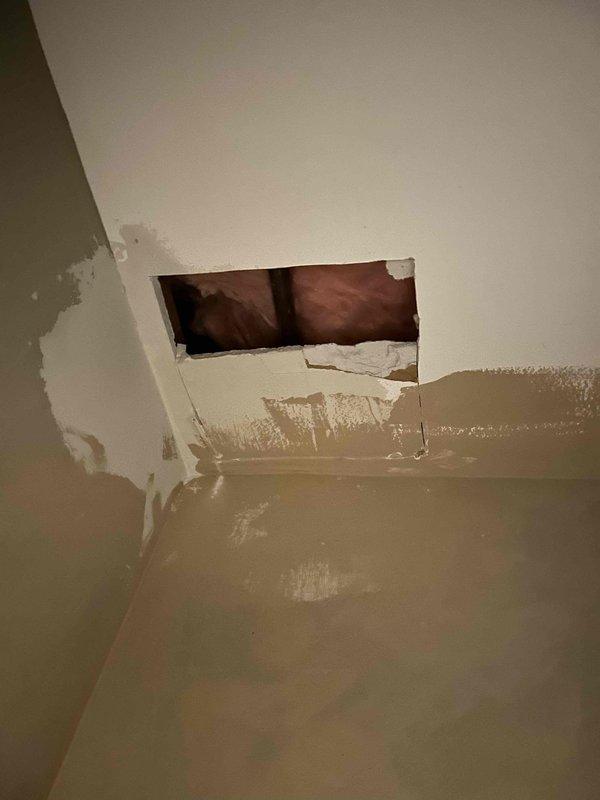 Responded to a service call for a busted hose bibb requiring repair. Upon initial diagnostic visit, assessed the damage and determined that proper repair would require a two-technician team due to access challenges and scope of work. The hose bibb showed signs of failure with associated water damage visible on interior wall and ceiling surfaces near the access point. Documented the condition through photographs showing the interior wall opening with water staining and deterioration, as well as the exterior copper pipe connection point on the concrete surface. Provided verbal estimate and scheduled return visit with appropriate crew size to complete the repair work properly.