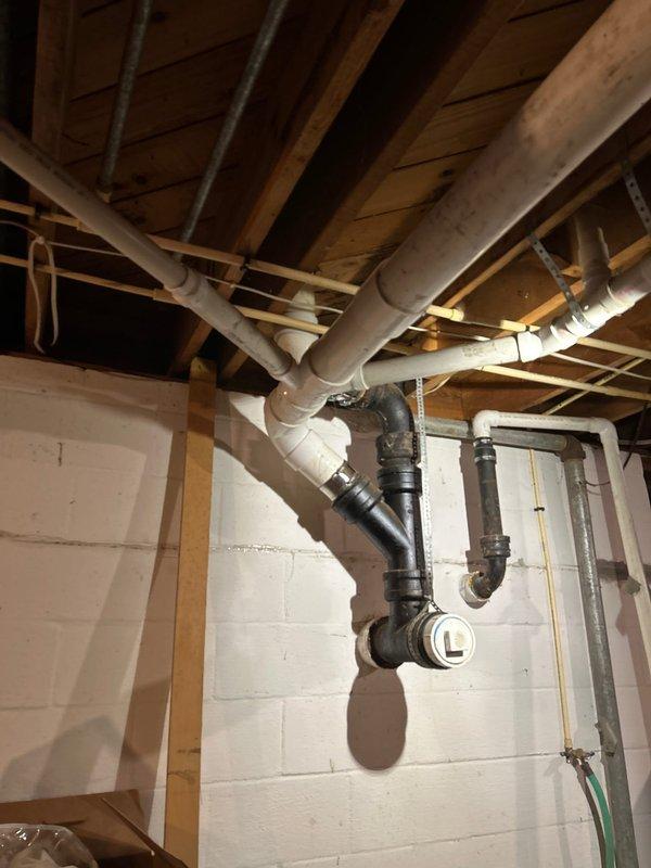 Removed deteriorated cast iron double-wye fitting and additional cast iron drain sections that were causing recurring line blockages in the basement plumbing system. Replaced all compromised cast iron components with new PVC drainage piping, ensuring proper slope and secure connections throughout. Conducted flush testing to verify complete drainage functionality and confirm the line was flowing freely without obstruction before completing the repair.