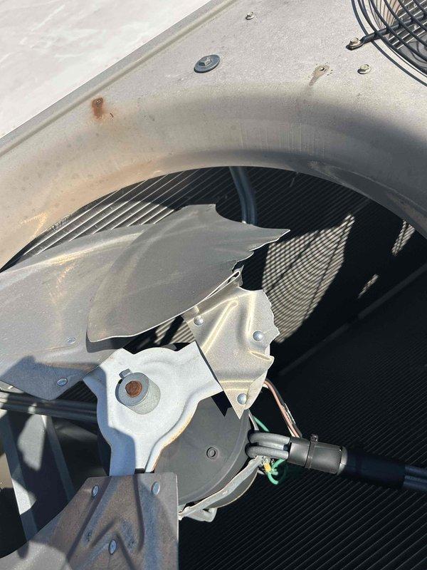 Responded to no cooling complaint at commercial facility with indoor temperature at 76°F and thermostat set to 70°F. Accessed rooftop HVAC unit (6 years old) and performed diagnostic inspection of blower assembly, fan motor, and internal components. Inspected evaporator coil, blower housing, motor assembly, and electrical connections. Documented condition of unit with photos showing fan assembly, internal components, motor wiring, and overall system condition for service records.