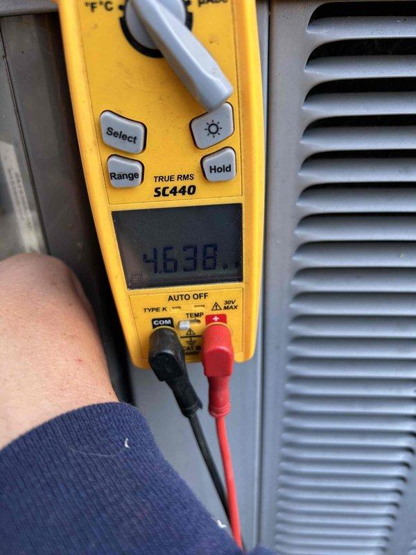 Completed annual Care Plan tune-up on air conditioning unit and gas furnace system located in crawlspace unit #413. Inspected and documented heavily soiled air filter showing significant dust and debris accumulation, which was noted as billable per service agreement. Performed temperature diagnostics using calibrated digital multimeter, recording operational reading of 46.38 degrees to verify proper system performance and cooling capacity.