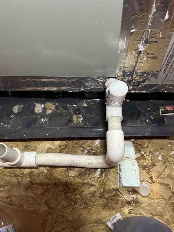 Completed scheduled care plan tune-up on heat pump and air handler system located in attic. During inspection, discovered severely compromised condensate drain line with visible vertical crack and deterioration requiring immediate attention to prevent water damage and system shutdown. Documented damaged PVC piping showing structural failure and discoloration, which posed risk of condensate overflow. Performed standard maintenance protocol including system operational checks, component inspection, and photographic documentation of deficient plumbing conditions for customer awareness and future repair coordination.