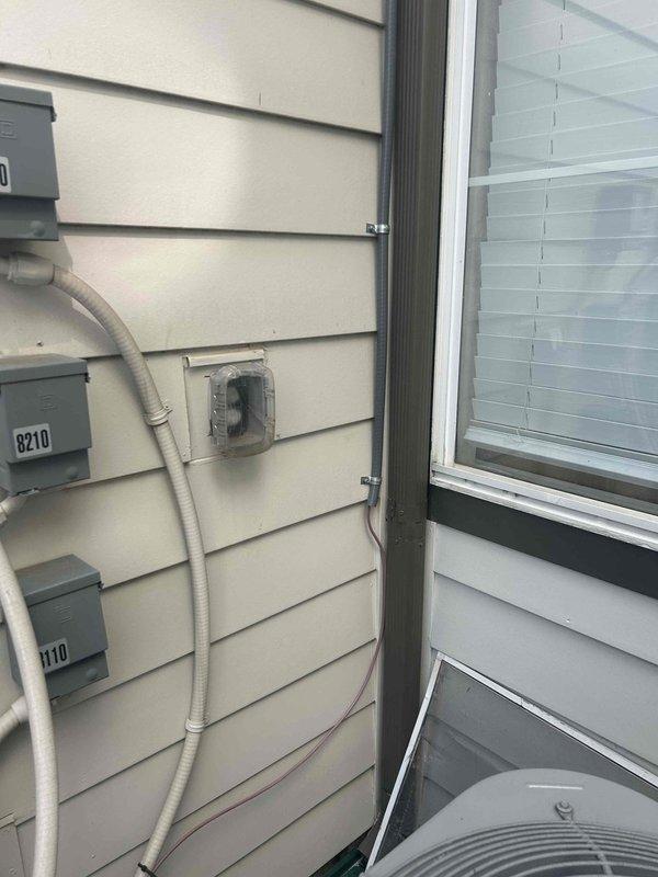 Completed commercial HVAC repair utilizing a two-person crew over four hours. Installed 50 feet of 18/8 thermostat wire and 50 feet of liquid-tight conduit to restore proper system communication and protect electrical components from environmental exposure. Documentation photos captured exterior building conditions, electrical meter installations, and HVAC condenser unit positioning to verify completed work and system accessibility.