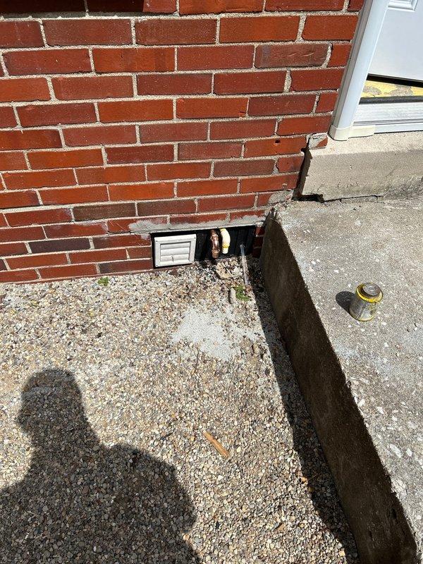 Addressed failed inspection items on gas tankless water heater installation. Rerouted temperature and pressure relief valve discharge line to exterior using proper CPVC piping per code requirements. Relocated condensate drain line to terminate outside the building, replacing non-compliant PE tubing with code-approved CPVC material where stubbed through exterior wall.