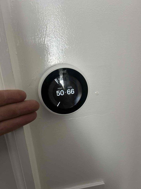 Responded to callback for geothermal system with two attic-mounted air handlers experiencing intermittent operation. Performed electrical diagnostics on control board of master bedroom zone unit that required manual resets to restore operation. Verified voltage readings at control panel and tested system components with multimeter to identify intermittent control issue. Removed all programmed schedules from Nest thermostats per customer request to eliminate unwanted temperature setpoint changes. Both zones tested and operational at time of departure.
