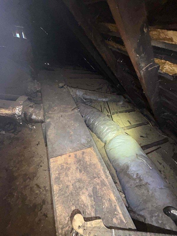 Responded to no cooling complaint on 15-year-old electric upstairs HVAC system where outdoor fan had not been operating for approximately two weeks. Upon arrival, accessed attic-mounted air handler and performed diagnostic testing on electrical components and control systems. Conducted visual inspection of ductwork, noting accumulated dust and age-related wear on flexible ducting, and assessed overall system condition in attic space. Performed electrical measurements and tested fan motor operation to identify failure point causing loss of cooling capacity.