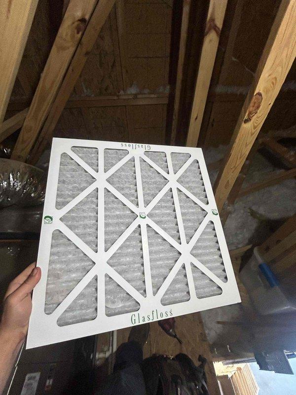 Completed monthly spring/summer maintenance on attic-mounted heat pump and air handler system accessed through garage. Performed electrical diagnostics using clamp meter on system wiring, recording amperage readings of 0.3A, and replaced 20x20x1 Glasfloss air filter as part of routine Club Single maintenance protocol.