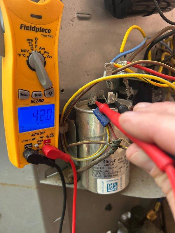 Completed comprehensive club membership maintenance service on residential HVAC system including one gas furnace, one air conditioning unit, and one humidifier. Performed electrical diagnostics on AC capacitor using Fieldpiece SC260 multimeter, testing voltage and capacitance readings to verify proper operation. Measured capacitor at 440V AC rated component, confirming electrical specifications within manufacturer tolerances. Inspected all wire connections and terminals on capacitor for secure contact and proper electrical continuity. Replaced 16x25x4 air filter in basement-located system. Conducted standard tune-up procedures on gas heating equipment and cooling system per club maintenance protocol. All components tested and found operating within normal parameters. System left in proper working condition.
