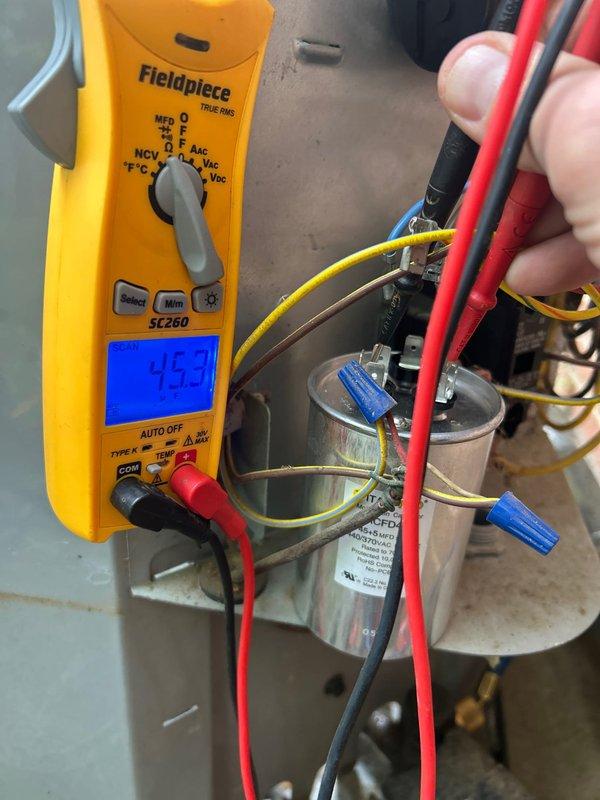Completed comprehensive club membership maintenance service on residential HVAC system including one gas furnace, one air conditioning unit, and one humidifier. Performed electrical diagnostics on AC capacitor using Fieldpiece SC260 multimeter, testing voltage and capacitance readings to verify proper operation. Measured capacitor at 440V AC rated component, confirming electrical specifications within manufacturer tolerances. Inspected all wire connections and terminals on capacitor for secure contact and proper electrical continuity. Replaced 16x25x4 air filter in basement-located system. Conducted standard tune-up procedures on gas heating equipment and cooling system per club maintenance protocol. All components tested and found operating within normal parameters. System left in proper working condition.