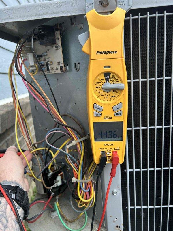 Completed monthly spring/summer maintenance on attic-mounted heat pump system accessible through garage. Performed electrical diagnostics using digital multimeter, measuring voltage and capacitance readings to verify proper system operation. Inspected condenser unit electrical components, control board, and wiring connections, confirming all circuits functioning within normal parameters.