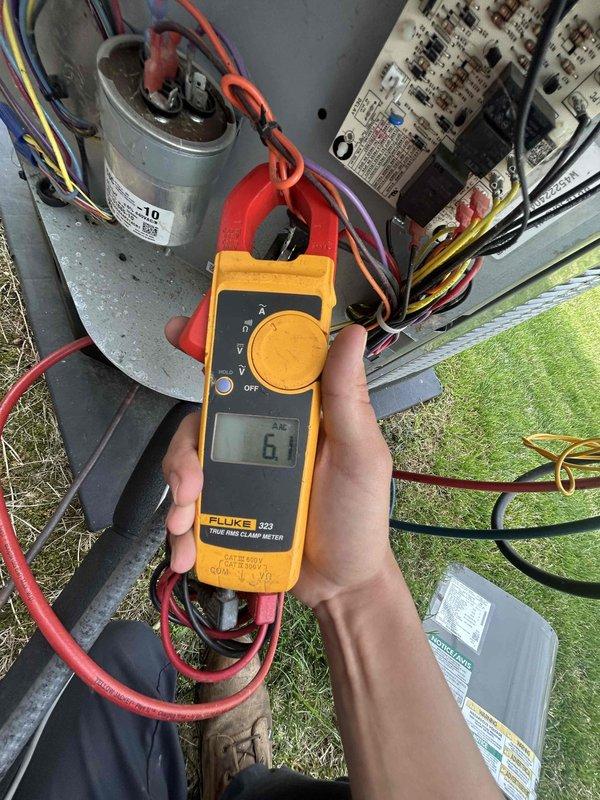 Performed routine spring/summer maintenance on heat pump and air handler system located in attic with garage access. Conducted electrical diagnostics using clamp meter, measuring compressor amperage at 5.5 amps and verifying proper current draw at 6 amps on system components. Inspected capacitor connections, control board operation, and all electrical wiring for proper function and safety compliance.