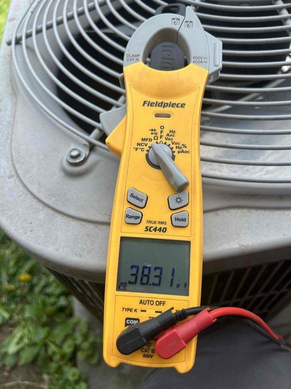 Responded to service callback for outdoor unit making unusual noise. Previous technician found no issues during initial visit. Upon arrival, performed diagnostic evaluation of condenser fan motor and compressor operation. Measured current draw at 383.1 amps using clamp meter to assess electrical performance. Inspected condenser fan motor showing signs of age, weathering, and dirt accumulation. Verified electrical connections on motor leads, noting some discoloration and potential corrosion at connection points. Recommended thorough inspection of contactor and capacitors to rule out electrical component failure before determining if condenser fan motor or compressor replacement is necessary.
