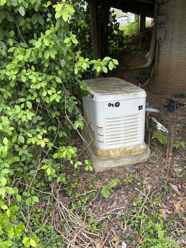 Performed comprehensive maintenance service on 22KW air-cooled standby generator (Model G0070132, S/N 3003679696) with 155.9 run hours. Conducted thorough inspection of physical installation and enclosure condition, noting environmental weathering and biological growth on exterior housing requiring future attention. Completed full fuel system inspection, battery electrical testing, and high/low voltage electrical connection verification with all systems testing within acceptable parameters. Replaced spark plugs, air filter, and oil filter as part of scheduled maintenance protocol. Performed valve adjustment as needed to manufacturer specifications. Executed complete system verification testing in both manual and automatic modes under load conditions, confirming proper operation and automatic transfer switch functionality. Unit operational and ready for service.