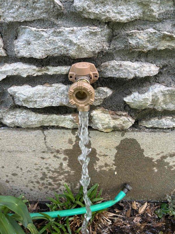 Responded to outdoor faucet leak that developed following winter freeze damage. Upon inspection, found 67-year-old hose bib actively leaking from the valve body and stem assembly. Due to age of fixture and extent of internal corrosion, determined repair was not viable. Removed and replaced failed outdoor spigot with new frost-proof sillcock assembly. Installed new brass valve with copper mounting flange, ensuring proper pitch for drainage and freeze protection. Tested new installation for proper operation and verified no leaks present at connections or valve body. Removed deteriorated original components from property.
