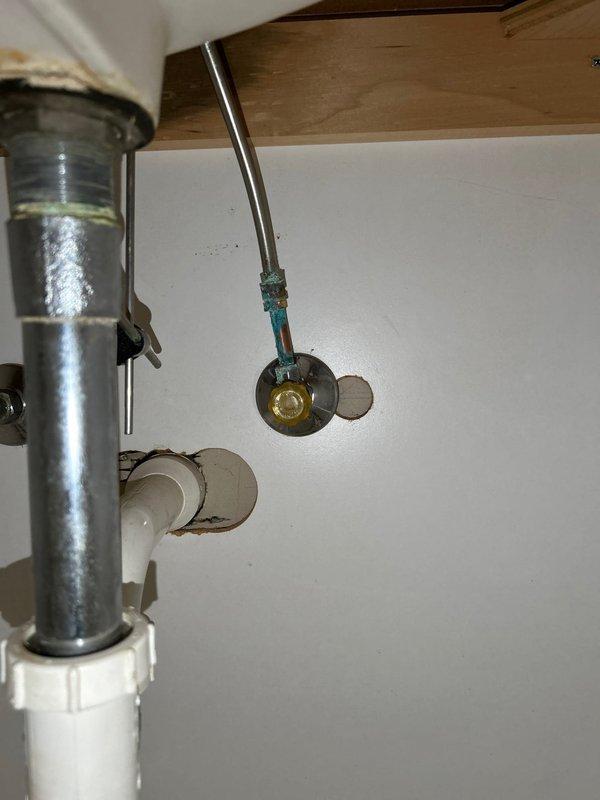 Responded to service call for toilet flushing issues and performed comprehensive plumbing assessment. Diagnosed and addressed toilet flush mechanism malfunction to restore proper operation. Inspected master bathroom plumbing fixtures and identified corroded shut-off valve beneath sink with visible green oxidation at connection point, requiring replacement for leak prevention. Evaluated faucet aerator flow performance and provided replacement recommendation. Verified sink supply lines and drain assembly condition. Conducted visual inspection of water heater unit to assess age, condition, and remaining service life for replacement planning purposes. Documented plumbing infrastructure with photographs showing under-sink corrosion and fixture conditions to support estimate preparation for recommended valve and aerator replacements.