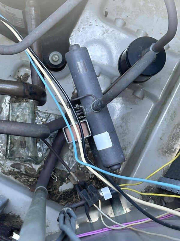 Responded to no cooling complaint on 15-year-old electric package unit blowing warm air. Upon arrival, found thermostat displaying 54°F current temperature with 75°F setpoint. Performed diagnostic inspection of outdoor package unit, accessing electrical compartment to evaluate system components. Inspected capacitor, contactor, wiring connections, and refrigerant lines. Unit showed signs of age with accumulated debris and weathering on exterior housing. Documented equipment condition with photos of thermostat operation and internal component layout including capacitor, wiring harness, and connection points for diagnostic purposes.
