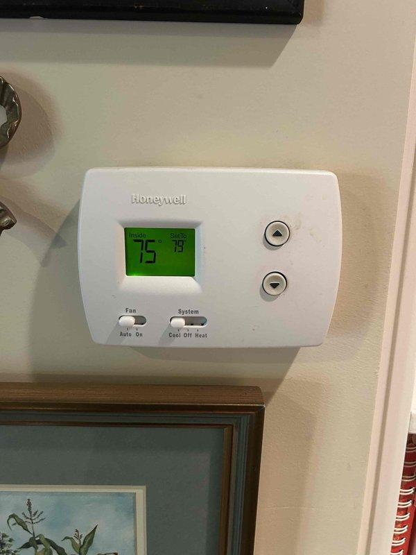 Completed routine HVAC maintenance on residential air conditioning system. Performed standard club membership service including inspection of indoor thermostat operation and outdoor condenser unit, verified proper system function with thermostat displaying 75°F setpoint and 79°F current temperature in heating mode. Customer provided air filters for installation during this maintenance visit.