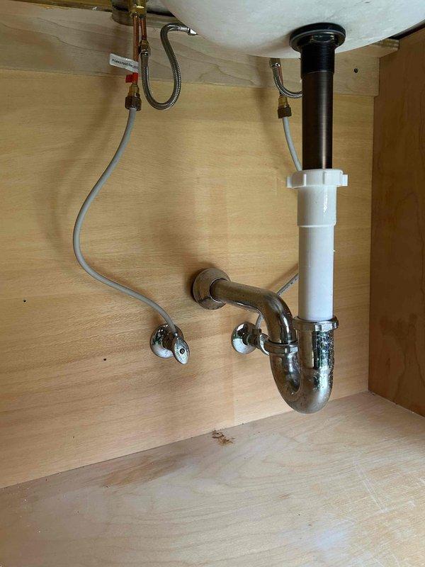 Responded to customer request to retain existing oil-rubbed bronze three-piece bathroom faucet instead of replacing with supplied model. Accessed under-sink plumbing through vanity cabinet and replaced defective internal faucet components including cartridges and seals while preserving original fixture to maintain aesthetic match with bathroom décor. Verified proper water flow and tested both hot and cold supply lines for leaks after reassembly. All plumbing connections secured and operational.
