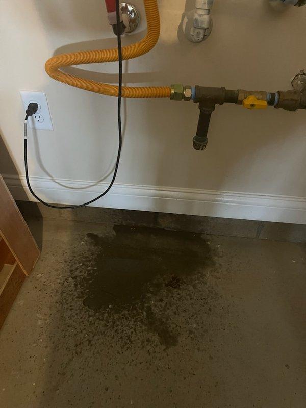 Responded to service call for Rinnai tankless water heater experiencing error codes 10, 11, and 49, with improper venting identified by roofing contractor. Upon inspection, confirmed venting system was incorrectly installed with improper pitch and inadequate penetration sealing through roof structure, causing condensate backup and triggering flame failure and ignition codes. PVC vent pipe showed incorrect angle through attic space without proper support or drainage slope, allowing condensate accumulation that resulted in visible water damage to flooring beneath unit. Diagnosed that improper venting configuration prevented adequate exhaust flow and caused unit malfunctions. Verified active manufacturer warranty coverage on unit itself, though labor charges apply for venting corrections. Provided detailed assessment of required venting repairs including proper vent pipe repositioning, correct pitch installation per manufacturer specifications, professional roof penetration sealing, and c