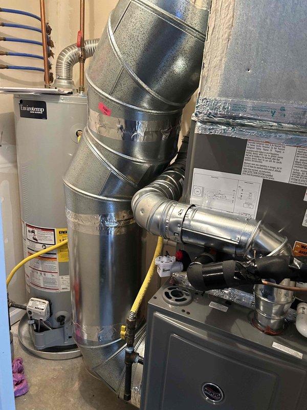 Completed full residential dual fuel HVAC system installation including RUUD 80% 75,000 BTU gas furnace (Model R801V0754A17UHSCAP), RUUD 2.5 ton evaporator coil (Model RCFY3617STANMC), and RUUD 2.5 ton 14.3 SEER2 two-stage heat pump (Model RP14AY30AJ2NA) with Honeywell digital WiFi thermostat configured for dual fuel operation. Installed transition to evaporator coil, standard air filter rack, electrical and gas shut-off switches, flexible gas line connector, and flame roll-out protection. Connected unit to existing flue piping, installed outdoor unit pad, and added two 14x14 fresh air grilles for proper ventilation. Modified flexible vent material to single pipe configuration, properly supported with hangers, and ensured adequate clearance from vent pipe per code requirements. Removed and disposed of existing equipment, obtained necessary permits, and verified all components meet code compliance standards.