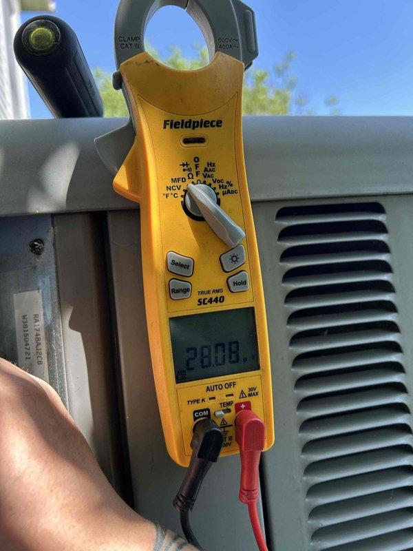 Completed preventative maintenance tune-up on dual HVAC system consisting of 10-year-old air conditioning unit and gas furnace located in basement and attic. Performed comprehensive diagnostics on outdoor condenser unit, measuring amperage draw at 29.08 amps and verifying system temperature at 72.5°F using calibrated clamp meter. Inspected electrical connections, refrigerant levels, and overall system performance on both units to ensure optimal operation for the cooling season.