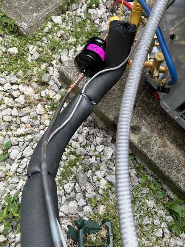 Successfully completed installation of a Bryant 15.2 SEER2 3-ton heat pump system with matching air handler and 15KW heat kit for second floor zone. Installed outdoor condenser unit on concrete pad with snow legs, electrical disconnect box, and whip kit, then ran insulated refrigerant lines with filter to indoor air handler. Mounted air handler with overflow drain pan equipped with water sensor, coil drain safety sensor, and proper trap, then integrated 20x30 filter return grille to replace existing undersized 20x25 grille and transitioned to existing ductwork. Installed digital WiFi thermostat for remote system control and monitoring. Removed and disposed of all existing equipment, obtained necessary permits, and verified system operation with proper refrigerant charge and airflow. System is now providing efficient heating and cooling with enhanced safety features and code-compliant installation.